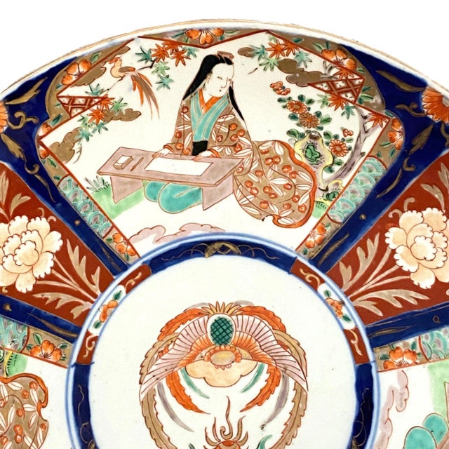 This is a wonderful large Meiji Period Japanese porcelain charger. The outer panels are decorated with ladies doing...