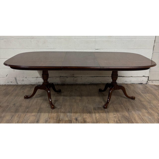 This is a stunning vintage Drexel Georgian style cherry double pedestal dining table with two leaves and table pad covers,...