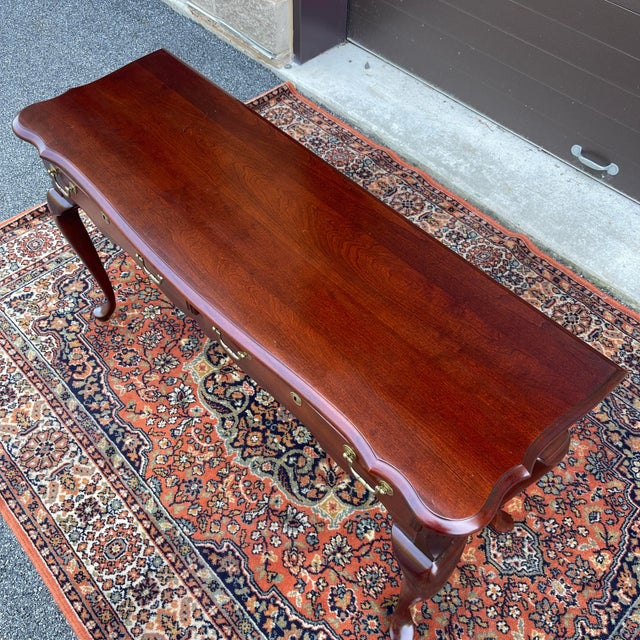 A late 20th century Pennsylvania House Traditional Queen Anne style solid cherry console or sofa table having a scalloped...