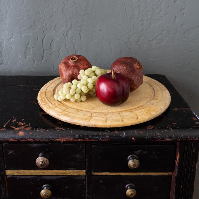 A lovely 19th-century English bread board features a wide, hand-carved wreath border, most likely made from Sycamore or...