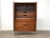 A mid century modern walnut and rosewood armoire dresser chrome legs running up the cabinet case. Made by Lane....