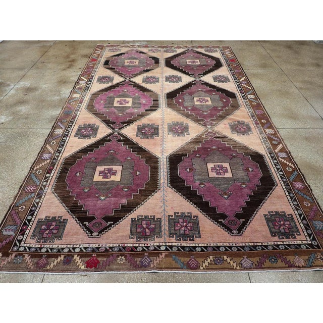 A vintage Turkish Anatolian long tribal room size carpet handmade during the mid-20th century. Measures: 9' 0" x 15' 2"