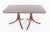 This elegant mahogany dining table is crafted in the Regency Revival style and stands on two substantial pedestal bases...