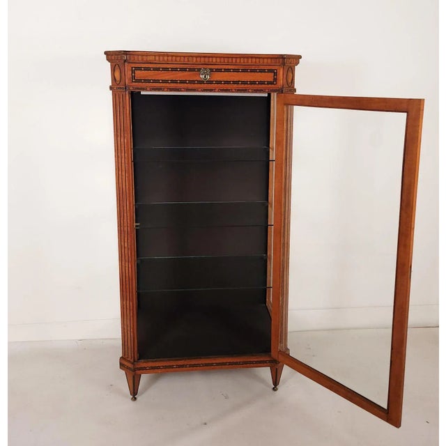 A Neoclassical inlaid display case or vitrine, made in Sweden, Russia, or Germany, early in the 19th century. Richly...