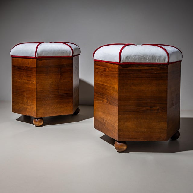 Pair of Art Deco stools with hexagonal walnut frames resting on ball feet. The seats have been newly upholstered in a...