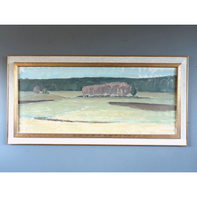 FIELDS AT FIRST LIGHT Size: 19.7 x 39.4 inches (including frame) Oil on canvas A tranquil mid-century landscape that...