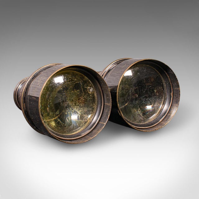 This is a pair of antique opera glasses. An English, leather and brass binocular by Ross of London, dating to the early...