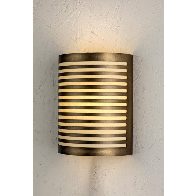 Pollux is a metal wall sconce made in Italy, characterized by a compact, contemporary shape. The perforated structure is...