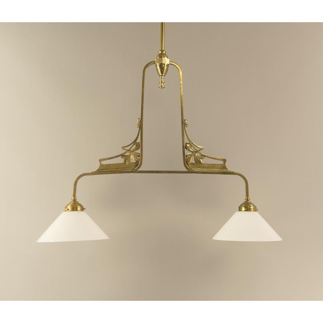 This two-armed hanging lamp for the dining or gaming table is a beautiful example of the Art Nouveau era. If required, the...