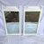 A pair of faux bamboo mirrors that have been newly lacquered in a high-gloss off white. Wires on the backs attach these...