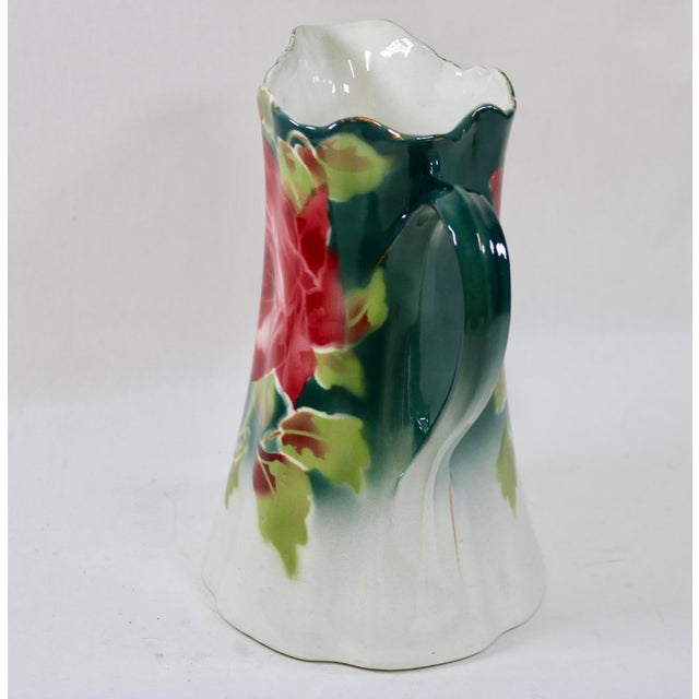 Bring timeless French country elegance to your home with this striking turn-of-the-century semi-porcelain water pitcher....