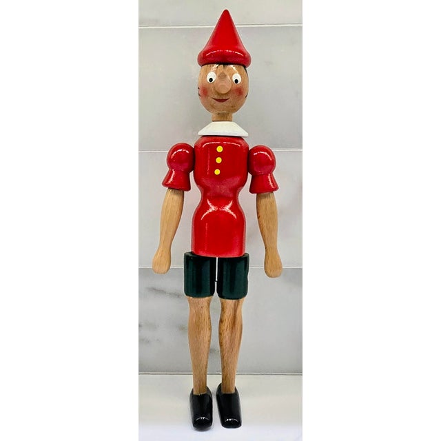 Celebrate classic Italian craftsmanship with this charming Mastro Geppetto Pinocchio wooden toy figure, fully marked...
