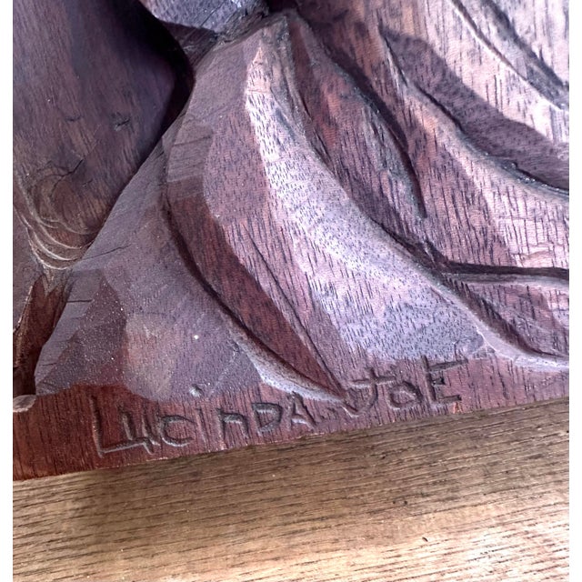 A striking vintage hand-carved wood relief portrait featuring deeply sculpted details and expressive character. Carved...