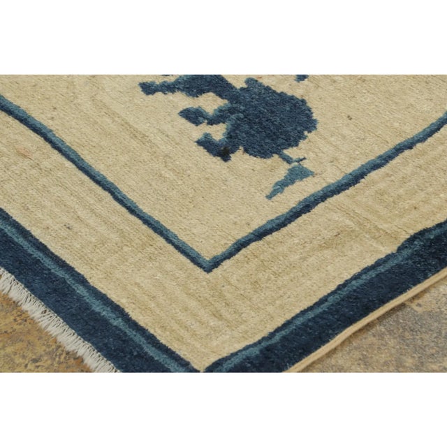 This 4x6 antique Chinese rug, hand-knotted in wool circa 1920–1929, features a distinctive pictorial design centered on a...