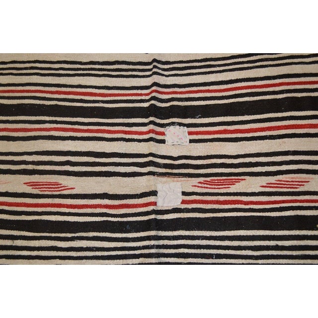 Hand-knotted with care using traditional rug-making techniques, this wool rug blends timeless craftsmanship with a modern...