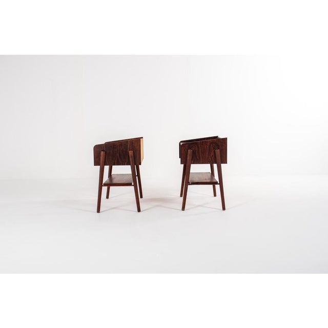 Beautiful pair of Danish mid-century bedside tables crafted in richly grained rosewood. These refined pieces feature a...