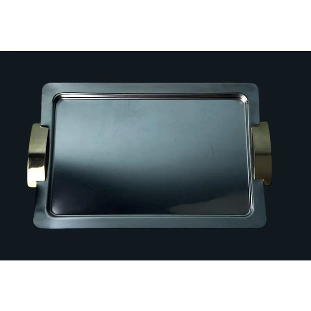 Sophisticated rectangular tray in polished 18/10 stainless steel (an alloy of exceptional quality and durability),...
