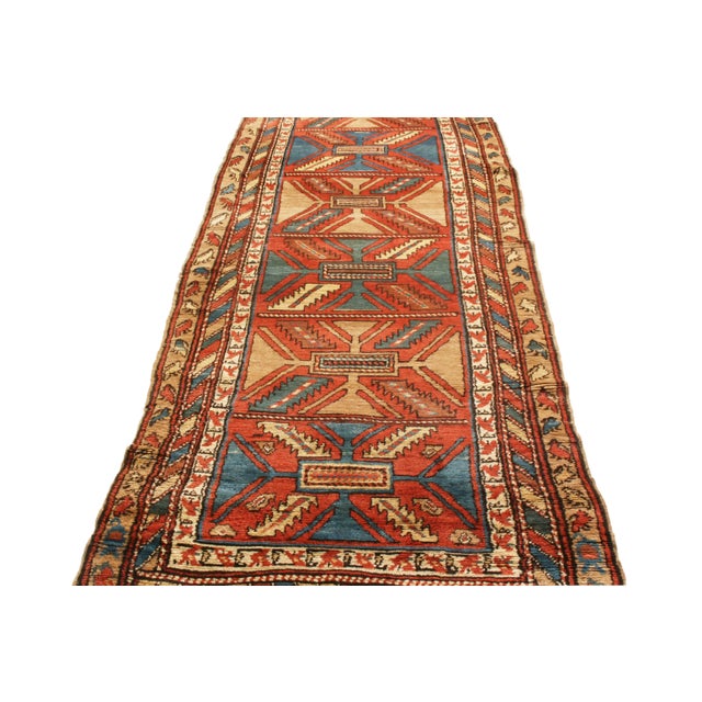 Originating from persia in 1910, this antique bakhshaish Persian runner features an uncommon minimalist approach to...