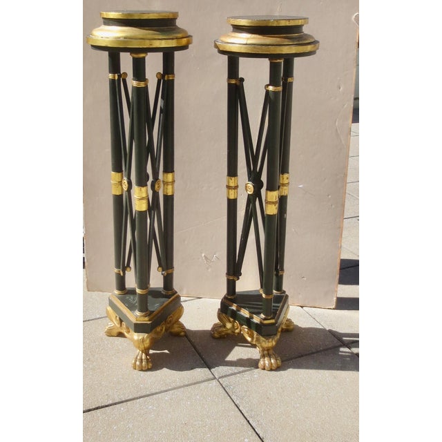 Black and gold-trimmed pedestals. Wooden and gilt pedestals, painted satin black and edged with gold-leaf trim. Very well-...