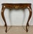 Elegant French Louis XV style console table crafted in wood with graceful curved lines and refined carved detailing. The...