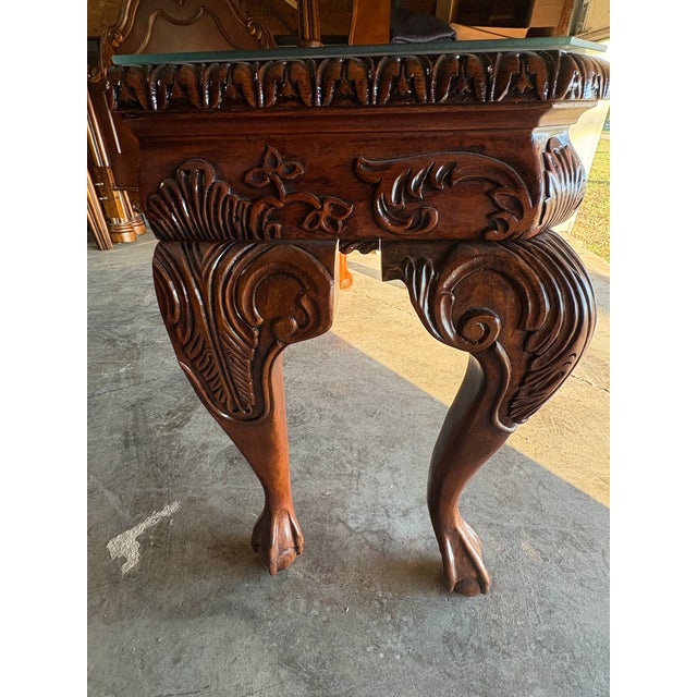 This stunning solid mahogany sofa table, crafted between 1990 and 2000, features exquisite carved details and a protective...