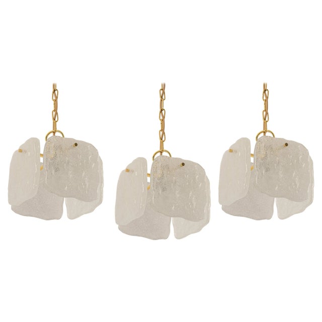 This is 1 of 3 petite stunning pendant lights by kalmar from the 1960s. The brass frame has 4 structured glasses,...