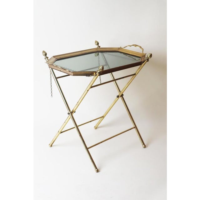 This high-quality folding table is crafted from brass and beautiful smoked glass. This beautiful table is elegant and...