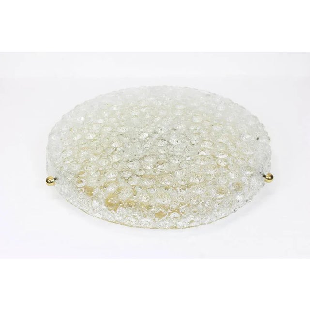 A wonderful round ice glass flushmount by hillebrand leuchten, germany, 1970s. Thick textured ice glass fixtured on a...