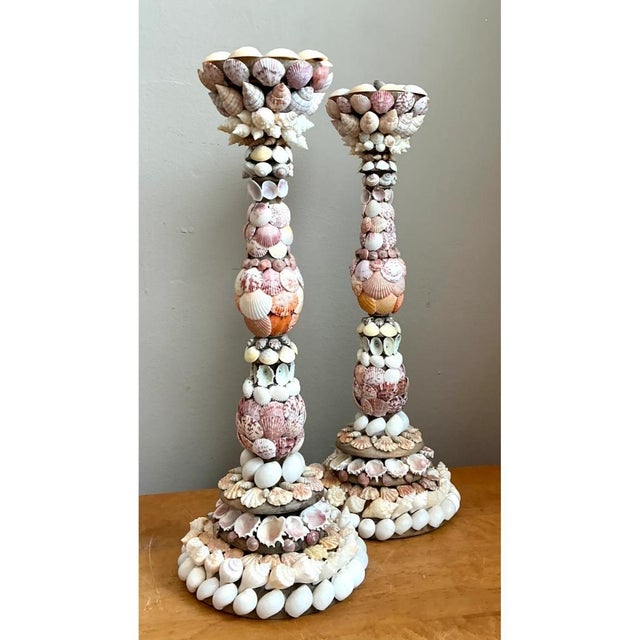 Exuding refined coastal charm and intricate organic artistry, this pair of vintage shell-encrusted candle holders makes a...