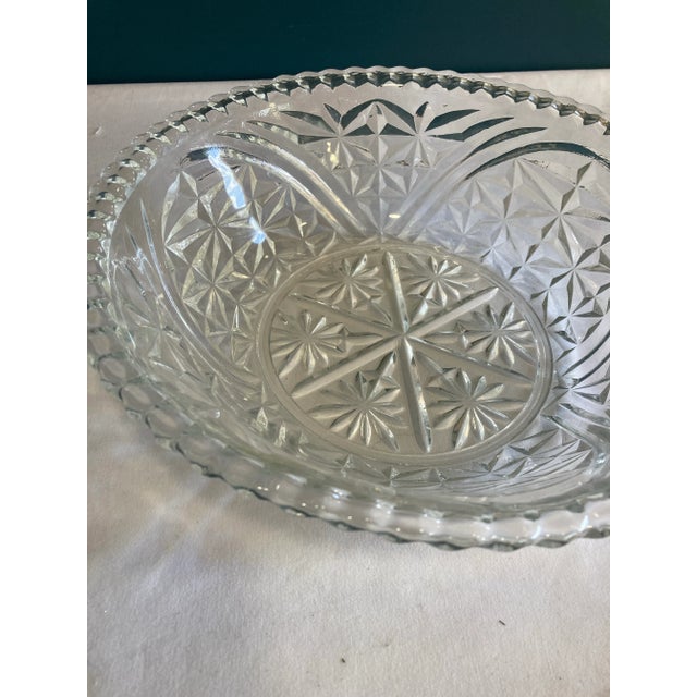 This beautiful serving bowl has cut glass flowers and stars. It also has a nice fluted edge.