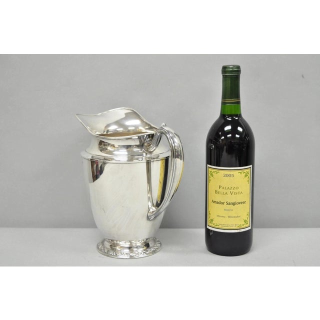 Vintage Oneida Briarcliff Victorian Silver Plated Water Pitcher. Circa Mid 20th Century. Measurements: 8.5" H x 9" W x 6" D.