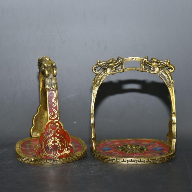 This is a matched pair of impressive antique cloisonné enamel stirrups, traditionally used for horseback riding and often...