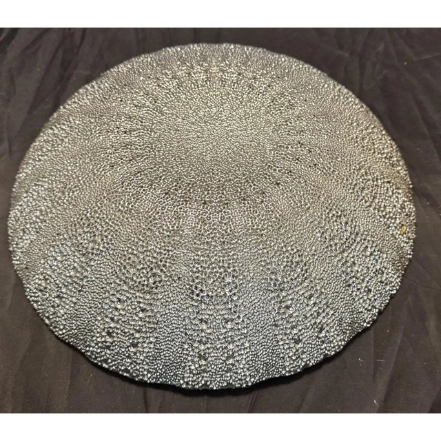 This decorative console bowl features a striking teal black scalloped edge design, adding an artistic accent to any room....