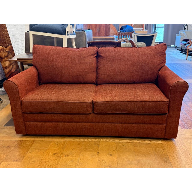 Design Plus Gallery presents the Leah Full Size Sleeper Sofa from La-Z-Boy. Upholstered in a textured rust-toned fabric,...