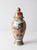 This vintage Chinese porcelain ginger jar from the mid-to-late 20th century features richly detailed Famille Rose-style...