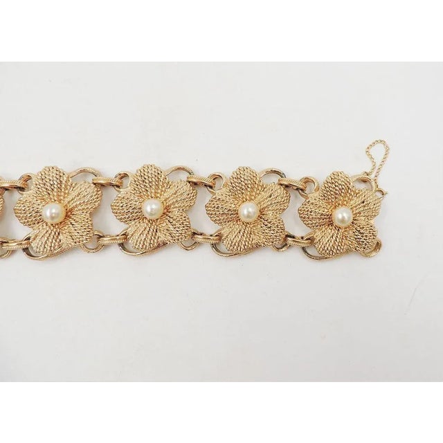 This is part of Chairish’s Costume Jewelry assortment. Hard to find 1950s textured goldtone and faux-pearl flower link...
