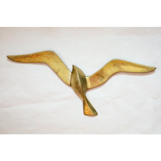 Elevate your space with this captivating set of three Mid-Century Modern brass flying seagull wall sculptures. Featuring...