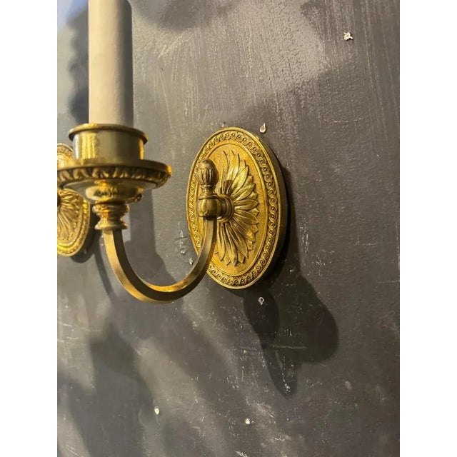 Pair of circa 1920’s gilt bronze one light sconces with sunburst design backplate