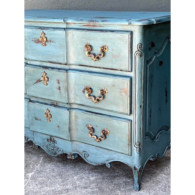 Infuse your home with the timeless allure of a European estate with this striking vintage French Provincial commode. This...
