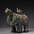 This striking antique bronze vessel, or zun, is finely modeled in the form of a standing elephant. The figure is richly...