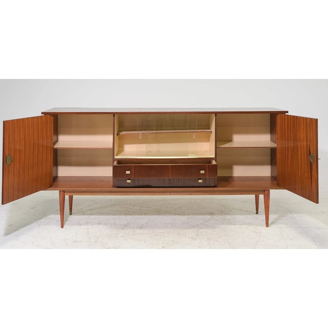 Elegant and functional, this French Mid-Century Modern sideboard showcases the clean lines and refined craftsmanship that...