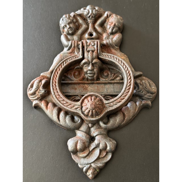 Offering for sale this awe-inspiring solid cast iron door knocker featuring a cherub motif. It measures 6.5" wide x 9"...