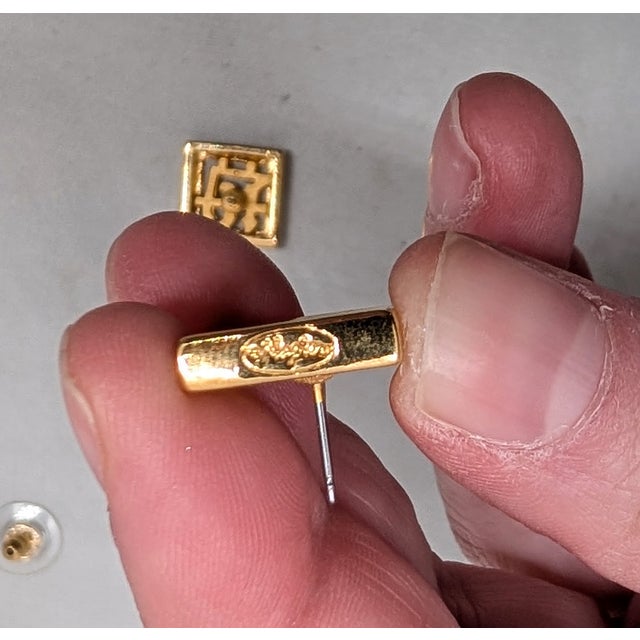 1970s square open work Chinese character pierced push back earrings. Marked "Napier©" in script on the edges of the...