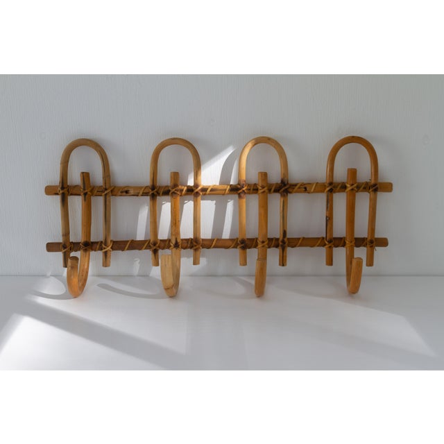 Charming wicker Mid-Century Modern bamboo wall mounted coat rack made in Italy in the 1950s. This lovely coat rack has...