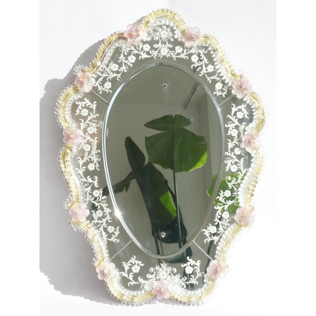A mid century Venetian style mirror made in Italy with a beautiful scalloped silhouette, adorned with delicate etched...