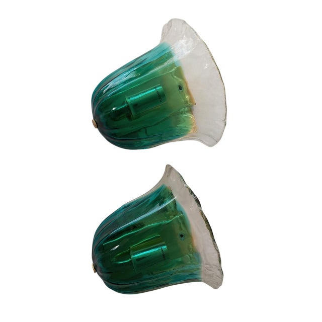 The design of these sconces exudes elegance and refinement, with the flower-shaped glass exquisitely blending green and...
