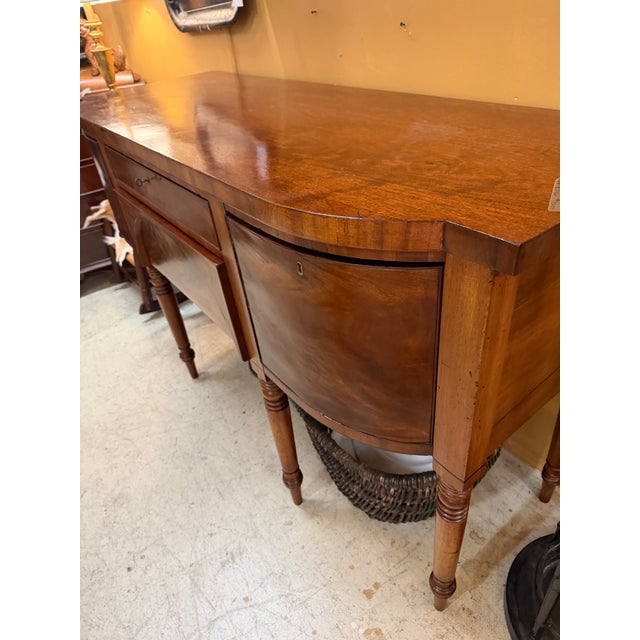 1900 - 1909 Regency/Federal Figured Mahogany Sideboard With Bowed Ends, Turned Legs, and the Distinctive Arched Center Panel. For Sale - Image 12 of 12