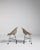 A pair of French mid-century accent chairs from circa 1960, combining a sturdy metal frame with upholstered cushioned...