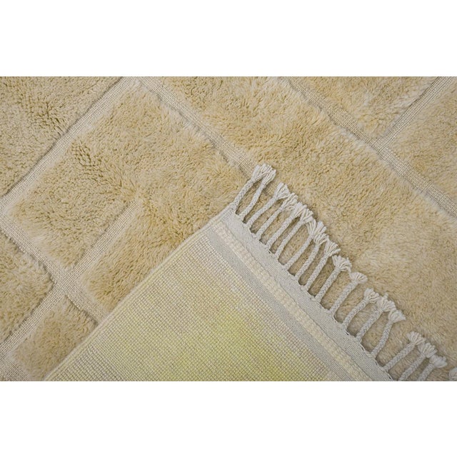 A soft, sun-warmed pastel yellow rug with a whisper-quiet geometric grid — minimalist, tactile, and endlessly easy to live...