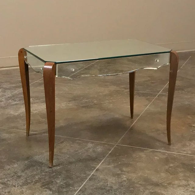 Mid-Century French Mirrored Coffee Table is a superb blend of natural wood with contoured mirrors that creates a graceful...